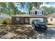 Charming two-story home featuring a stone facade, manicured lawn, and a welcoming front entrance at 208 Se Lincoln N Cir, St Petersburg, FL 33703