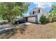Well-maintained two-story home featuring a two-car garage and landscaping on a sunny day at 208 Se Lincoln N Cir, St Petersburg, FL 33703