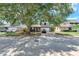 Charming two-story home with well-maintained landscaping and a large tree providing shade at 208 Se Lincoln N Cir, St Petersburg, FL 33703