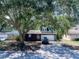 Inviting two-story home with attached garage, mature trees, and well-maintained landscaping at 208 Se Lincoln N Cir, St Petersburg, FL 33703