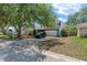 Inviting two-story home with attached garage and well-manicured lawn under a shady tree at 208 Se Lincoln N Cir, St Petersburg, FL 33703