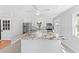 Bright modern kitchen featuring stainless steel appliances, white cabinetry, and a large kitchen island at 208 Se Lincoln N Cir, St Petersburg, FL 33703
