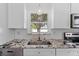 Close up of kitchen sink featuring granite countertops and stainless steel appliances at 208 Se Lincoln N Cir, St Petersburg, FL 33703
