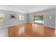 Living room with hardwood floors and a view of the pool through sliding glass doors at 208 Se Lincoln N Cir, St Petersburg, FL 33703