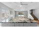 Spacious living room with ceiling fans and sliding glass doors to the pool at 208 Se Lincoln N Cir, St Petersburg, FL 33703