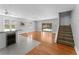 Open-concept living room with hardwood floors, lots of natural light, and convenient access to the backyard pool at 208 Se Lincoln N Cir, St Petersburg, FL 33703