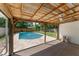 Relaxing covered patio overlooking the sparkling pool and lush backyard, perfect for outdoor entertaining at 208 Se Lincoln N Cir, St Petersburg, FL 33703