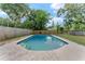 Inviting backyard pool surrounded by lush landscaping, creating a serene outdoor retreat at 208 Se Lincoln N Cir, St Petersburg, FL 33703