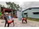 Comfortable patio seating adjacent to house, features a nice chimney and wooden deck with shade at 2192 Robinson Dr, St Petersburg, FL 33710