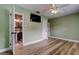 Bedroom with green walls, light fan, and ensuite bathroom with modern fixtures at 2192 Robinson Dr, St Petersburg, FL 33710