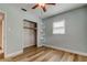 Bright bedroom features wood floors, a ceiling fan, closet and custom shelving at 2192 Robinson Dr, St Petersburg, FL 33710