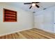 Bedroom has wood floors, ceiling fan, closet with sliding doors and a built-in bookshelf at 2192 Robinson Dr, St Petersburg, FL 33710