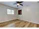 Bedroom has wood floors, ceiling fan, a window and a built-in bookshelf at 2192 Robinson Dr, St Petersburg, FL 33710