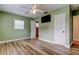 Light filled bedroom with green walls, closet, and light colored waterproof vinyl flooring at 2192 Robinson Dr, St Petersburg, FL 33710