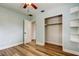 Light-filled bedroom with wood floors, ceiling fan, closet, and views to other rooms at 2192 Robinson Dr, St Petersburg, FL 33710
