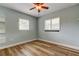 Cozy bedroom with ample natural light from shuttered windows and vinyl plank flooring at 2192 Robinson Dr, St Petersburg, FL 33710