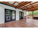 Wooden deck with a metal roof overlooking the pool, accessible via double doors at 2192 Robinson Dr, St Petersburg, FL 33710