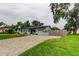 Charming single-story home with a well-manicured lawn, brick driveway, and light blue exterior at 2192 Robinson Dr, St Petersburg, FL 33710
