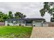 Charming single-story home with a well-manicured lawn, brick driveway, and light blue exterior at 2192 Robinson Dr, St Petersburg, FL 33710