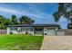 Charming single-story home with a well-manicured lawn, brick driveway, and light blue exterior at 2192 Robinson Dr, St Petersburg, FL 33710