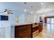 Kitchen island with cooktop and seating, flowing into living room with a ceiling fan at 2192 Robinson Dr, St Petersburg, FL 33710