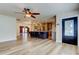 Open-concept living space with kitchen featuring wooden cabinets, stainless appliances, and seating at kitchen island at 2192 Robinson Dr, St Petersburg, FL 33710