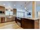 Open kitchen featuring stainless steel appliances, wooden cabinets, island cooktop and sink with a view at 2192 Robinson Dr, St Petersburg, FL 33710