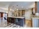 Modern kitchen featuring a large island with seating, stainless steel appliances, and stylish cabinetry at 2192 Robinson Dr, St Petersburg, FL 33710
