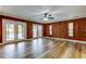 Gathering room with wood paneling and double doors that open to the backyard and pool area at 2192 Robinson Dr, St Petersburg, FL 33710