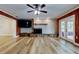 Bright living room featuring a fireplace, wood floors, and doors leading to the back deck at 2192 Robinson Dr, St Petersburg, FL 33710