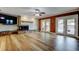 Bright living room featuring a fireplace, wood floors, and doors leading to the backyard pool area at 2192 Robinson Dr, St Petersburg, FL 33710