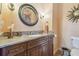 Bathroom with dark wood cabinets, granite countertop and brushed nickel fixtures at 2513 Martucci Rd, Seffner, FL 33584