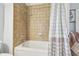 A clean bathroom featuring a tiled shower-tub combination, offering a functional and well-maintained space at 2513 Martucci Rd, Seffner, FL 33584