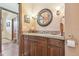 Bathroom with dark wood cabinets, granite countertop and brushed nickel fixtures at 2513 Martucci Rd, Seffner, FL 33584