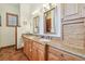 Bathroom vanity with double sinks, granite countertop, and wood cabinets with lots of storage at 2513 Martucci Rd, Seffner, FL 33584