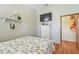 Bedroom with bed, TV, shelving, and doorway into another room at 2513 Martucci Rd, Seffner, FL 33584