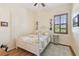 Bedroom featuring wood-look floors, a four-poster bed, and a window with wood trim and shutters at 2513 Martucci Rd, Seffner, FL 33584