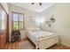 Bedroom features a window, wood-look floors, desk, and bed with side table and lamp at 2513 Martucci Rd, Seffner, FL 33584