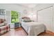 Bright bedroom with wood floors, large window, closet, and a comfortable bed offering a cozy retreat at 2513 Martucci Rd, Seffner, FL 33584