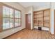 Bright room with a window, wood-look floor and built-in shelves ready for a buyer's personal touch at 2513 Martucci Rd, Seffner, FL 33584