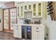 This kitchen features a beautiful coffee bar with wine fridge and outdoor access at 2513 Martucci Rd, Seffner, FL 33584