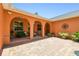 Charming courtyard features arched doorways and a cozy seating area, creating an inviting outdoor space at 2513 Martucci Rd, Seffner, FL 33584