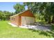 A close-up view of the orange two-car garage with a gray roof and concrete driveway at 2513 Martucci Rd, Seffner, FL 33584