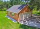 Aerial view of the detached garage, showcasing white rock landscaping and dual garage doors at 2513 Martucci Rd, Seffner, FL 33584