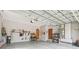 Spacious garage featuring two entry doors, storage shelves, and access to the home's utilities at 2513 Martucci Rd, Seffner, FL 33584