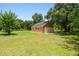 Spacious detached two-car garage on a lush green lawn offers extra space and storage at 2513 Martucci Rd, Seffner, FL 33584
