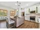 The kitchen features stainless appliances, a large island with bar seating and tile floors at 2513 Martucci Rd, Seffner, FL 33584