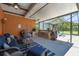 Lanai with seating area, outdoor kitchen, and a view of the green yard at 2513 Martucci Rd, Seffner, FL 33584