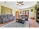 Cozy living room features a ceiling fan, tile floor, and a beautiful area rug at 2513 Martucci Rd, Seffner, FL 33584
