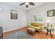 Comfortable living room with hardwood floors, a bright window with shutters, and a view of the outside at 2513 Martucci Rd, Seffner, FL 33584